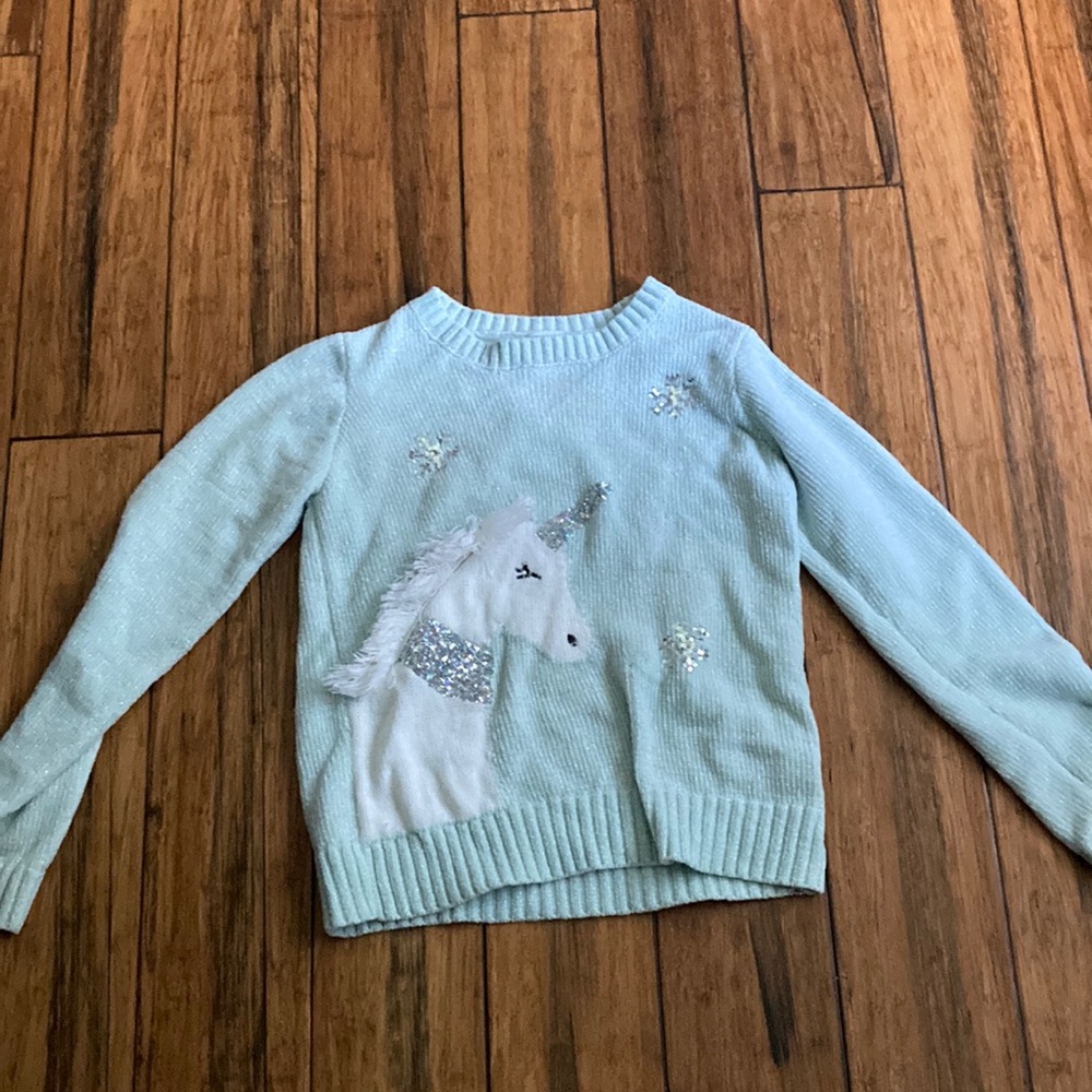 I am selling a unicorn sweater it is teal and new